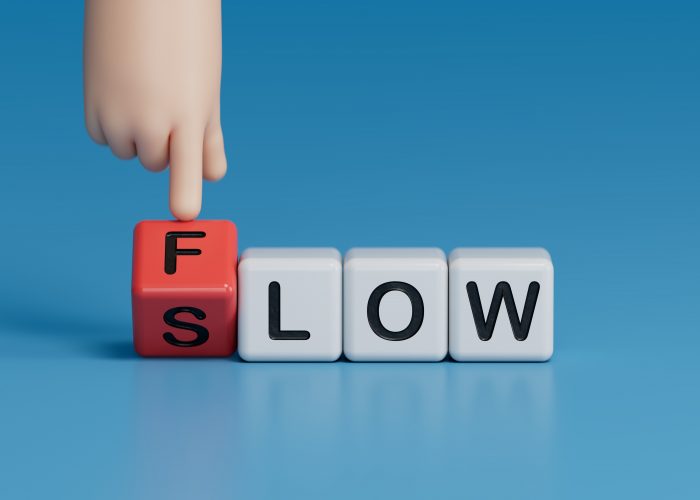 Flow and Slow symbol. Concept words Flow and Slow on wooden cubes. Businessman hand. Business and Flow and Slow concept. Copy space.3D rendering on blue background.
